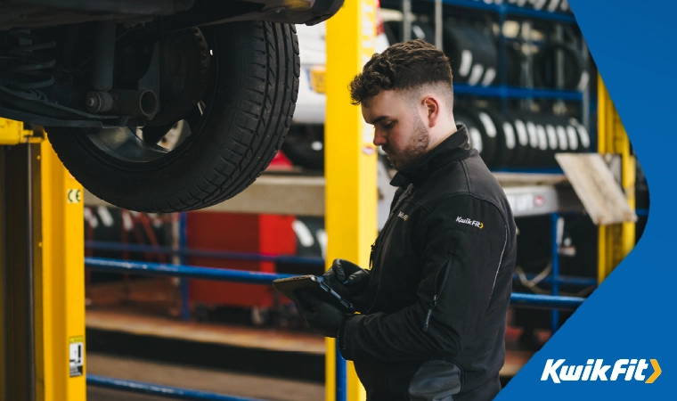 kwik fit technician working on a car